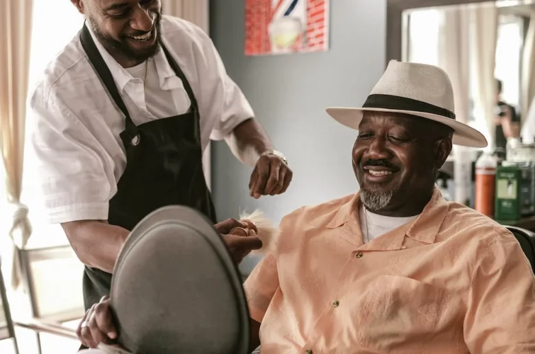 A barber ensuring he has providing excellent service to his customer