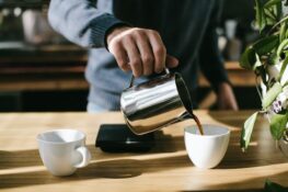 person-pouring-coffee-in-white-ceramic-mug