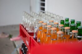 Close up shot of bottles of soft drinks in a crate- Carbonated drinks