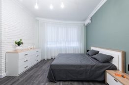 bedroom-interior-with-furniture and air-conditioning under-glowing-lamps-at-home